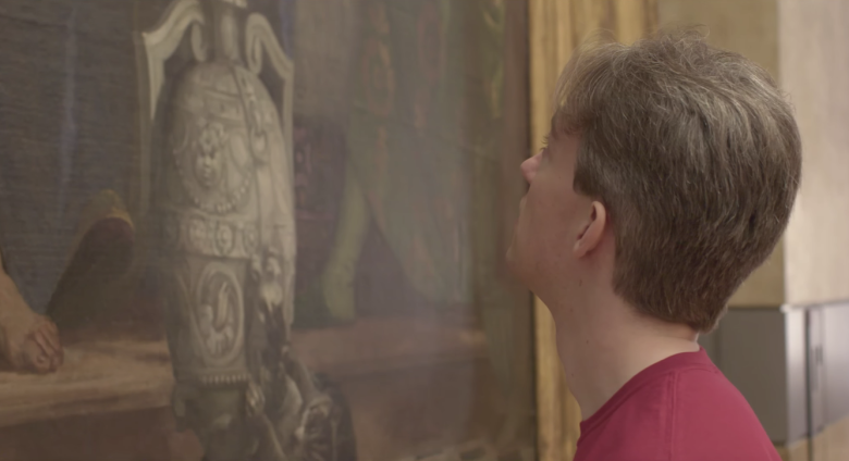 man stares at detail of The Wedding Feast at Cana