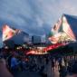 People attending an event held in the square in front of the European Film Centre CAMERIMAGE building, 2022. License